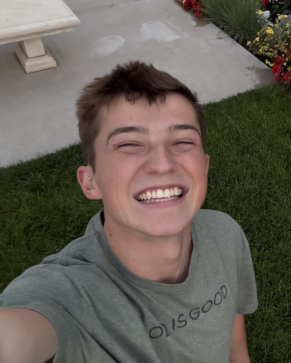 Tanner Yost laughing, photographed on the lawn of the Rexburg Idaho Temple grounds.